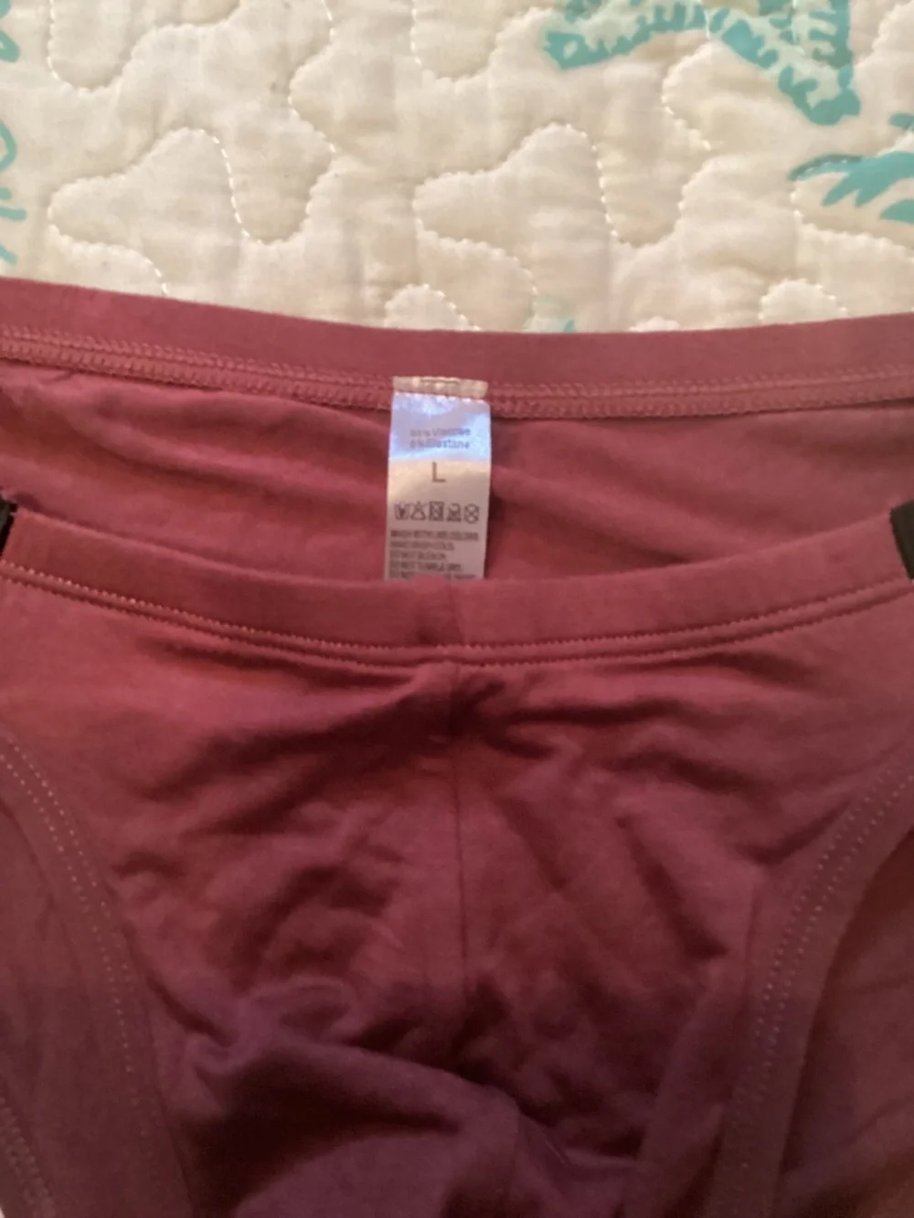 Sexy, burgendy color brief with black side straps.